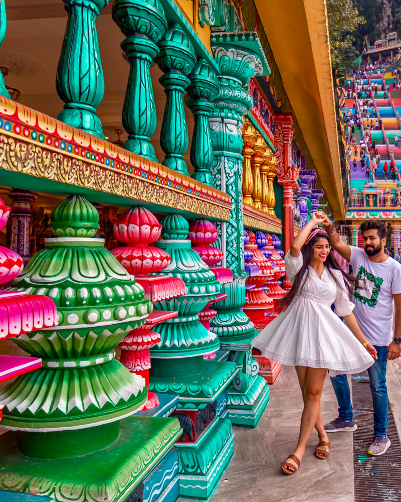 A couple in white twirling at Batu Caves