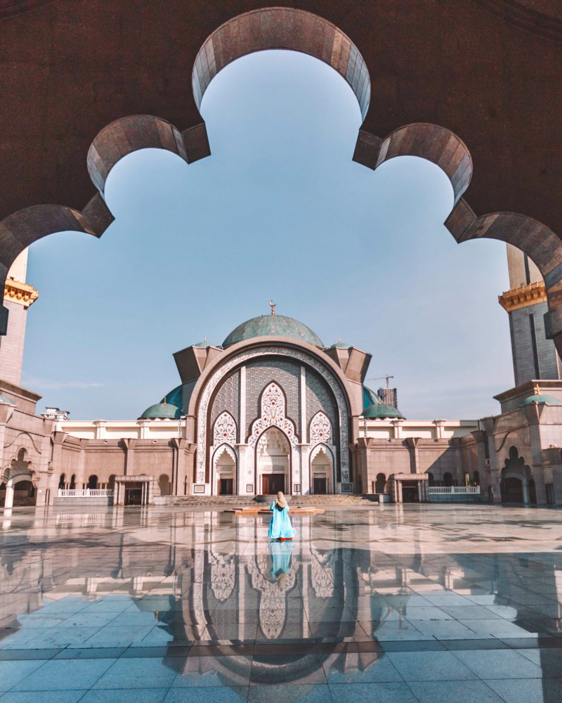 A girl in Abaya standing in the corridor of Wilayah Mosque