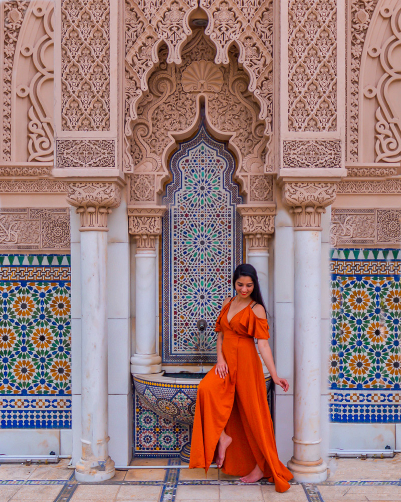 A girl in orange dress posing at astaka morocco pavillion in kuala lumpur