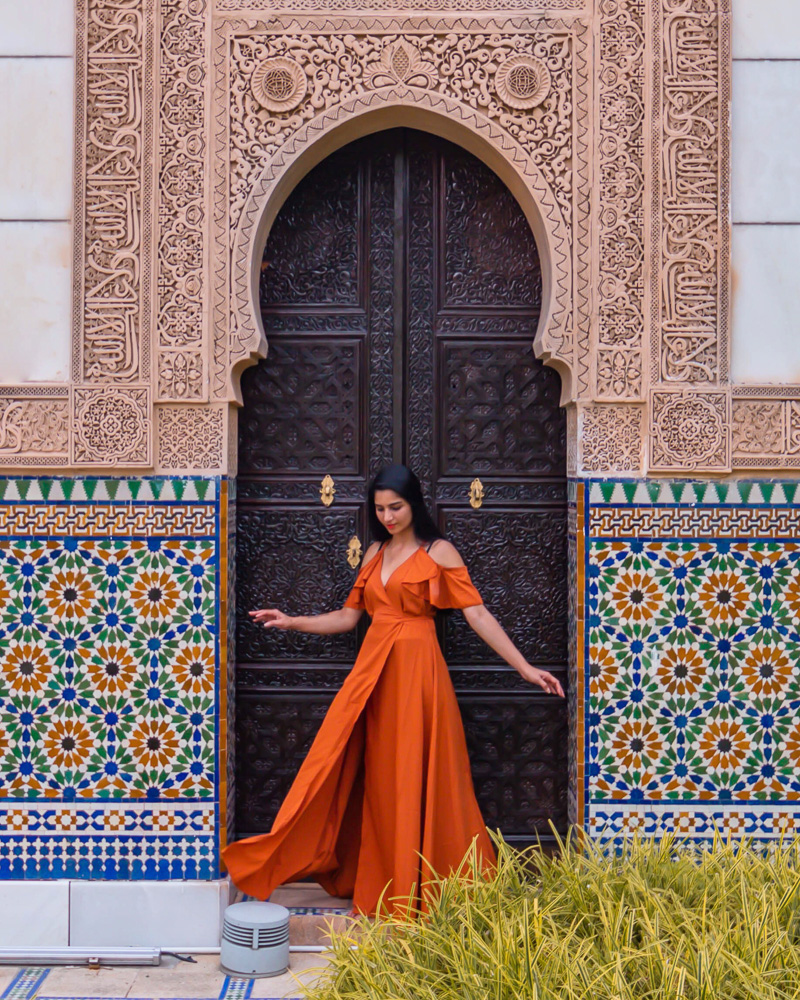 A girl in orange dress posing at astaka morocco pavillion in kuala lumpur