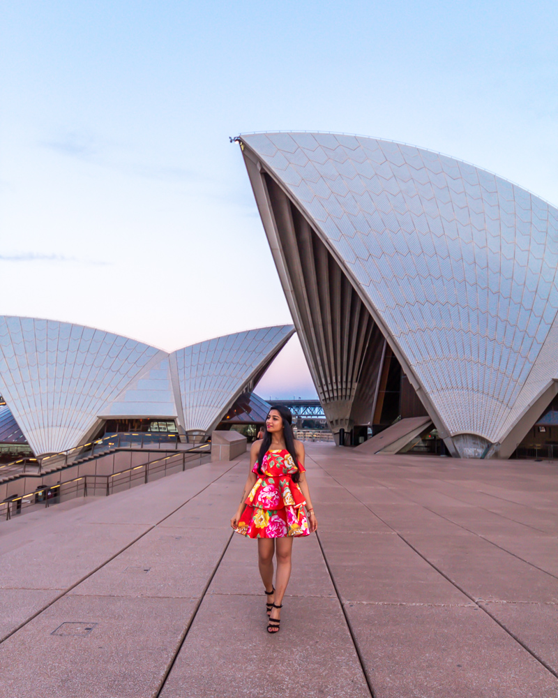 A girl in red dress with a view of Sydney opera house
