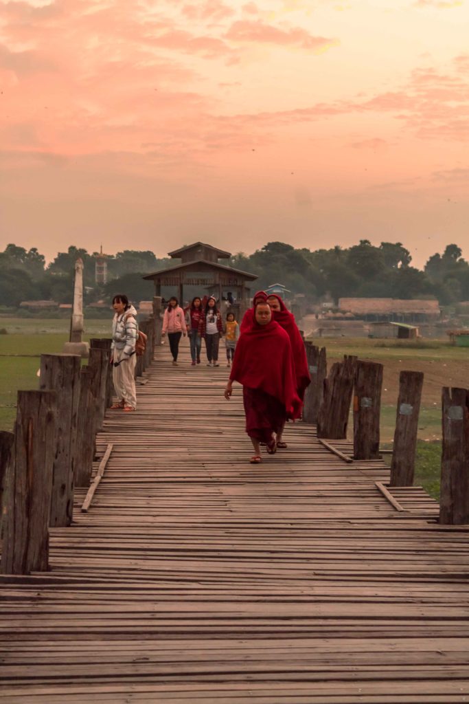 Monks and locals enjoying the walk at U Bein Bridge during sunrise