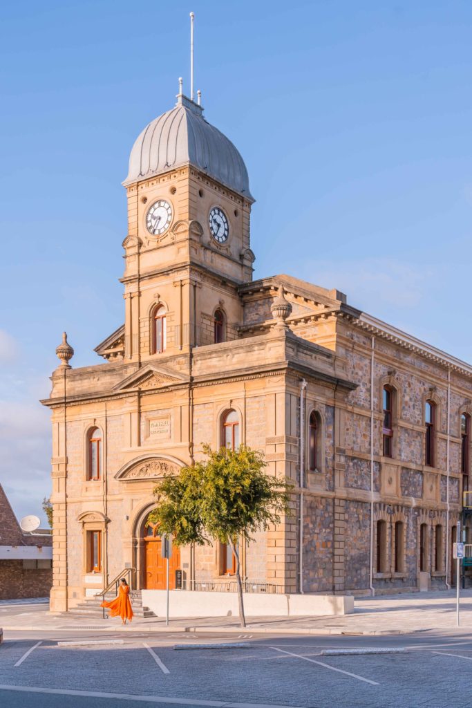 A girl in orange dress in the pretty town of Albany during the road trip from Perth to Esperance