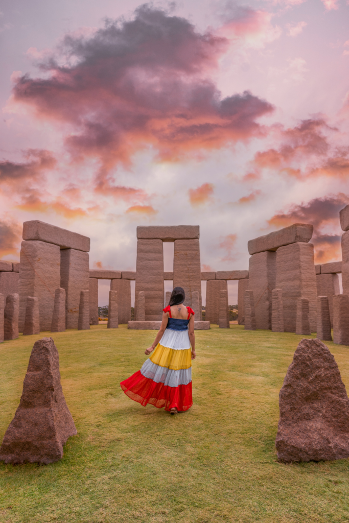 A girl in colorful dress facing the back of camera and showing one of the best places to see in Esperance, The Esperance Stonehenge