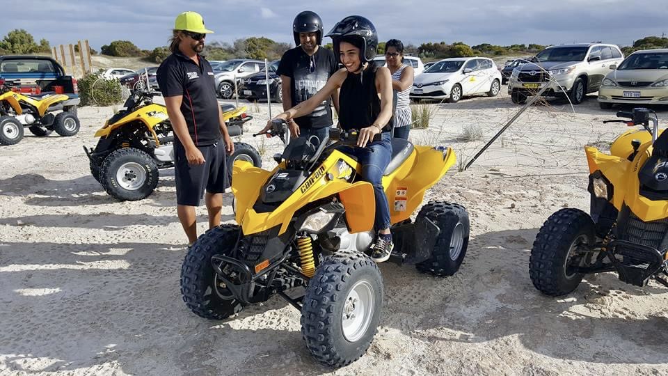 A girl trying quad biking at the dunes in western australia
