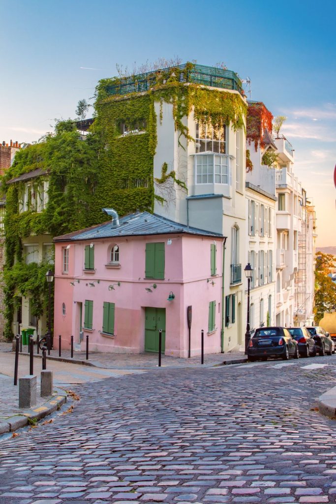 The pink-colored cafe with a green ivy wall in Montmartre is one of the most Instagrammable places in Paris.